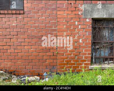 a pair of iron gate windows on an old brick warehouse building Stock Photo