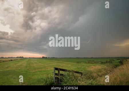 Thunderstorm with lightning bolt is moving across the dutch landscape Stock Photo