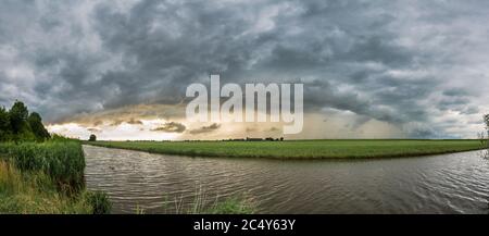 Evening panorama of a storm with arcus cloud over the dutch landscape Stock Photo