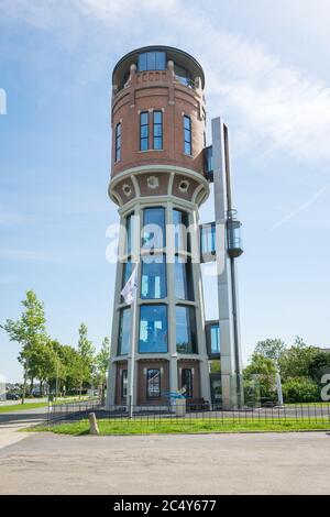Old water tower along the river 'Old Rhine' (dutch: Oude Rijn) in western part of Holland. Nowadays the tower is used as office. Stock Photo