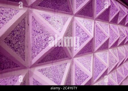 Diminishing Perspective of Purple Pink Colored Geometric Concrete Wall for Abstract Background Stock Photo