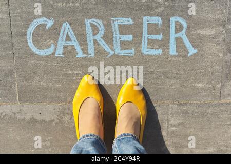 Career concept, top view on woman legs and text written in chalk on gray sidewalk Stock Photo