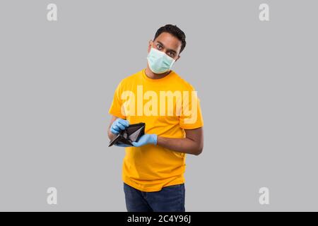 Man Watching Empty Wallet Wearing medical mask and Gloves. No Money Concept. No Salary Stock Photo