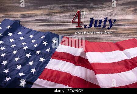 Happy 4th of July USA Independence Day greeting card with American national flag on a old wooden. Stock Photo