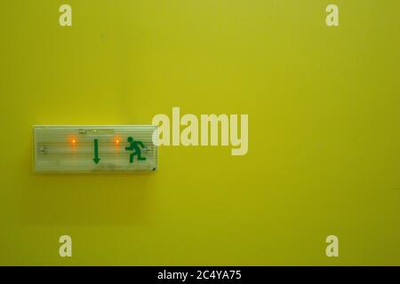 electrical exit sign on green wall Stock Photo