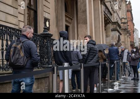 Glasgow, Scotland, UK. 29th June, 2020. Shoppers standing in line outside the Apple store on Buchanan Street as shops are now allowed to reopen for business today with the further easing of the coronavirus lockdown rules. Credit: Skully/Alamy Live News Stock Photo