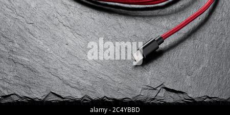 usb Lightning mobile charging cable on stone background Stock Photo