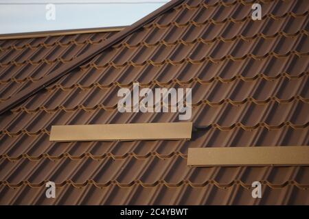 Close-up of brown tiled roof in sunny day. Stock Photo