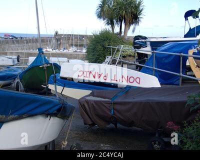 An upside-down boat with 'Don't Panic' painted on it. No worries, no panicking, calm, chill, optimistic, quirky, humorous, funny thing Stock Photo