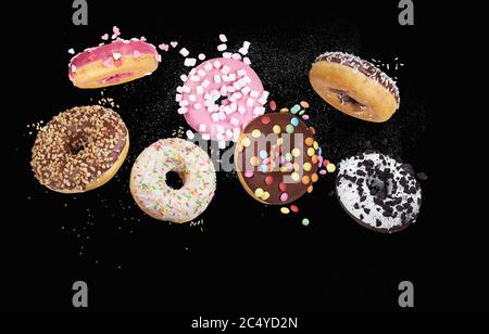 colorful donuts on black background Stock Photo