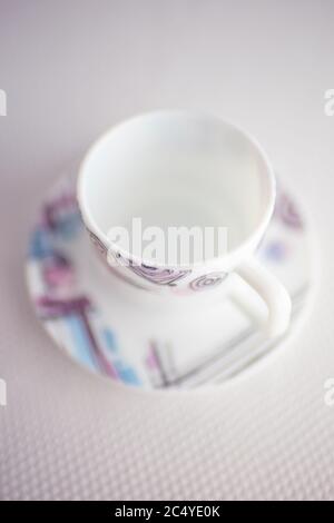 Cup and saucer on the white table. Modern crockery for tea with a modern pattern. Selective art focus. Stock Photo