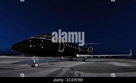 business jet. black plane is parked Stock Photo