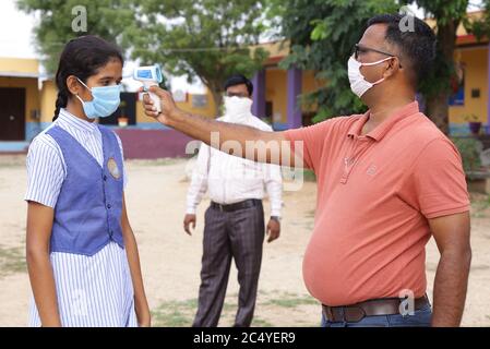 Beawar, India. 29th June, 2020. (6/29/2020) Students undergo temperature scanning as they arrive to appear in the 10th standard board exam, amid COVID-19 pandemic in Beawar. Around 11 lakh students to appear in the class X social science exam of Rajasthan Board of Secondary Education (RBSE) in more than 6,000 examination centres across the state. All the social-distancing norms were followed during the exam. (Photo by Sumit Saraswat/Pacific Press/Sipa USA) Credit: Sipa USA/Alamy Live News Stock Photo