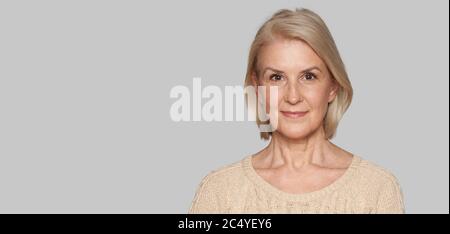 Close up portrait of beautiful older woman smiling. Isolated Stock Photo