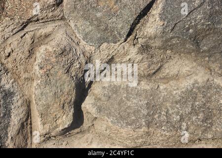 Grunge texturized natural stone wall exterior,background not seamless. Stock Photo