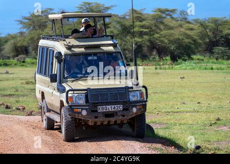 Tourists in a Toyota wildlife safari vehicle on a game drive, Amboseli National Park, Kenya, Africa Stock Photo