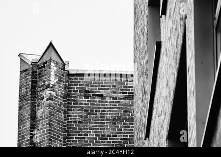 Brick wall with pointed end, hard and high-contrast in black and white Stock Photo
