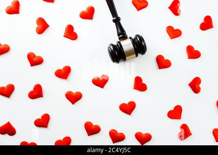 Gavel surrounded by red hearts isolated on white, love for justice and Judge law medical Pharmacy compliance Health care business rules. Stock Photo