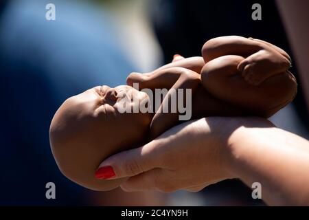 Washington, DC, USA. 29th June, 2020. A Pro-Life activist holds a 22 week fetal model during a rally outside the United States Supreme Court in Washington, DC, U.S., on Monday, June 29, 2020. The Court delivered a 5-4 ruling blocking a restrictive abortion law in Louisiana Monday morning. Credit: Stefani Reynolds/CNP | usage worldwide Credit: dpa/Alamy Live News Stock Photo