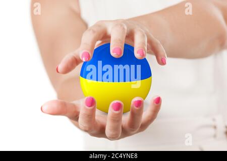 Two Woman Hands Protecting Ukraine Flag Earth Globe Sphere on a white background. Stock Photo
