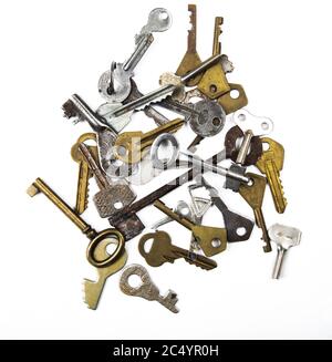 Bunch of assorted old multi-colored metal antique keys of different shapes isolated on white background. Home security concept. Stock Photo