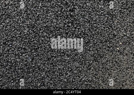 Black colored granulated material texture Stock Photo