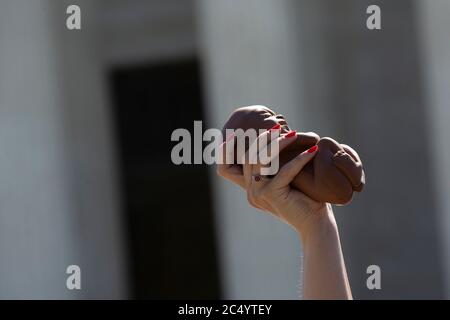 A Pro-Life activist holds a 22 week fetal model during a rally outside the United States Supreme Court in Washington, DC, U.S., on Monday, June 29, 2020. The Court delivered a 5-4 ruling blocking a restrictive abortion law in Louisiana Monday morning. Credit: Stefani Reynolds/CNP /MediaPunch Stock Photo