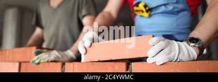 Bricklayers st construction site laying bricks Stock Photo