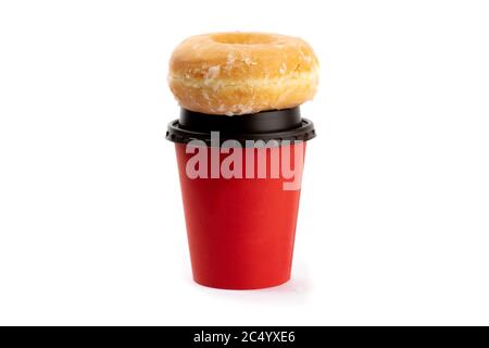 a honey dipped donut on top of a red takeout coffee cup isolated on white Stock Photo