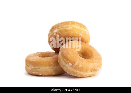 a pile of three honey glazed doughnuts isolated on white Stock Photo