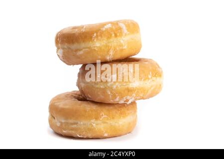 a stack of three sugar dipped doughnuts isolated on white Stock Photo