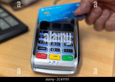 A customer making a contactless card payment. Stock Photo
