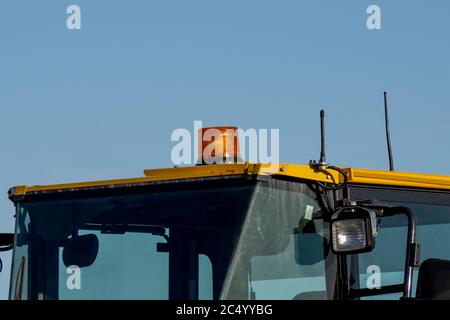 the roof of the operators cab of a yellow backhoe Stock Photo