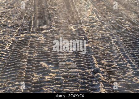 tyre tracks in the sand from  a large vehicle on a beach Stock Photo
