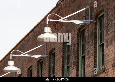 Old style light fixtures on an old brick warehouse wall Stock Photo