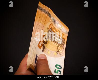 Hand holding bunch of banknotes: various concepts Stock Photo