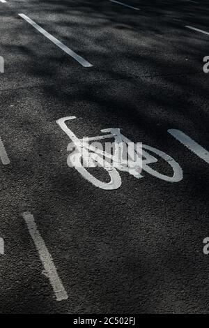 The symbol of a bicycle with lane markings on a road indicating it is a cycle lane. Stock Photo