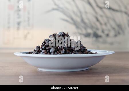 Salted preserved black beans in a bow. Stock Photo