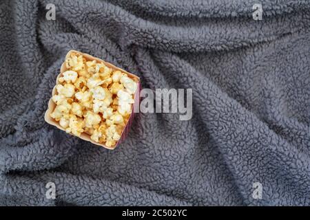 Top view of popcorn box on fluffy blanket Stock Photo