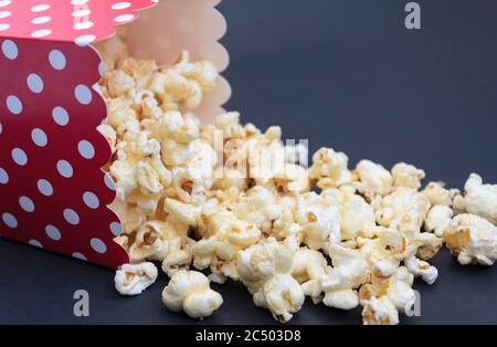 Popcorn falling out of the box on black background Stock Photo