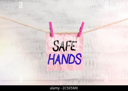 Conceptual hand writing showing Safe Hands. Concept meaning Ensuring the sterility and cleanliness of the hands for decontamination Clothespin rectang Stock Photo