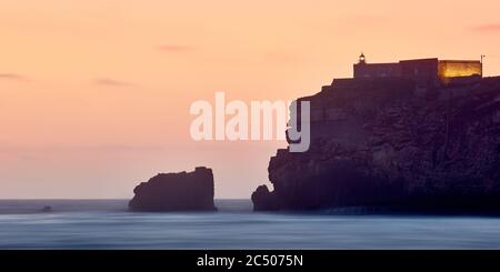View of Nazare's lighthouse in Zon North Canyon, place with the biggest waves in Europe Nazare, Portugal. Stock Photo