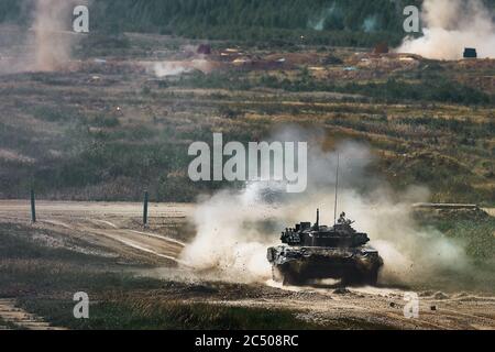 Shot from a tank. Russian tank shot on range. Smoke, explosions, military Stock Photo