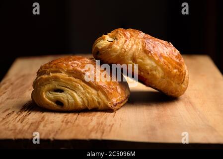 two pain du chocolat on a board Stock Photo
