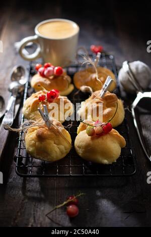 Buns with morning coffee.Sweet breakfast.Muffins with fruits.Healthy food and drink. Stock Photo