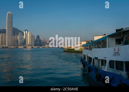 The Star Ferry in Kowloon, Tsim Sha Tsui with a view of the sky scrapers on Hong Kong island. Stock Photo