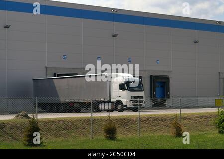 Place loading and unloading  trucks. A truck during unloading in a distribution center. Stock Photo