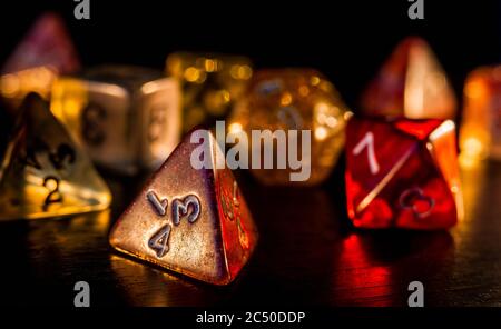 Colorful and shiny role playing dices close-up on a dark background. RPG or board game concept. Stock Photo