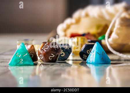 Colorful dices with different shapes and number of faces used to play role playing game and board game close-up. Stock Photo