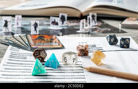 Role playing game set up with dices, board, cards, character sheet and book. RPG concept. Stock Photo